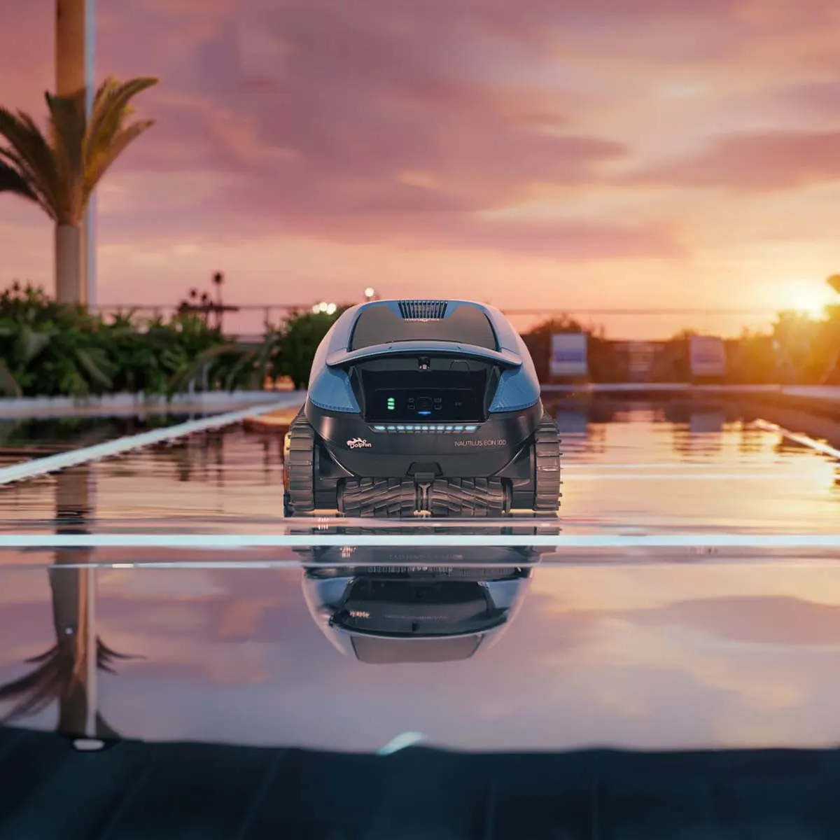 Two Dolphin EON robots on a pool ledge at sunset