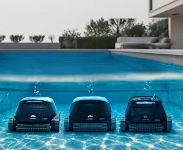 Three Dolphin robots lined up on a pool floor